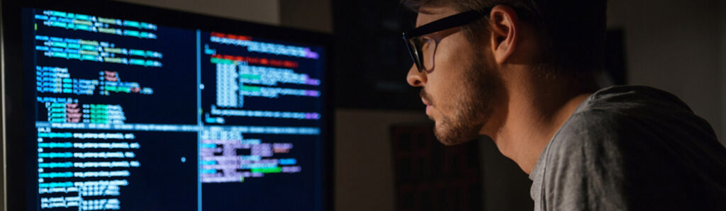 Man eating and looking at screen